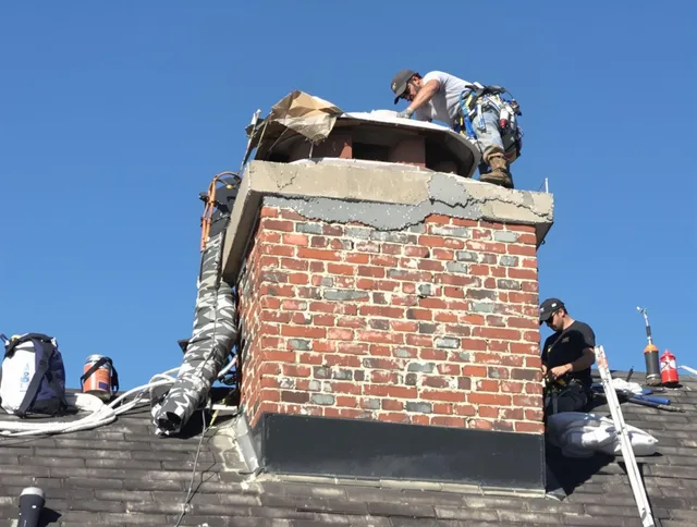 Winthrop Chimney Sweep installing a custom chimney crown in Winthrop, MA